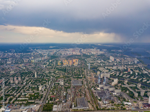 Spring rain over Kiev. There are black thunderclouds in the sky, dark rain falls on the city. Aerial drone view. © Sergey