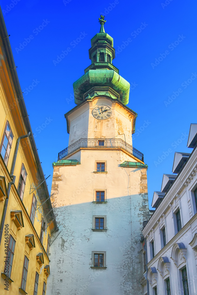 Michael's Gate -  city gate that has been preserved of the medieval fortifications in the Old town of Bratislava, Slovakia. Yellow light and shadow on the facade of the gate