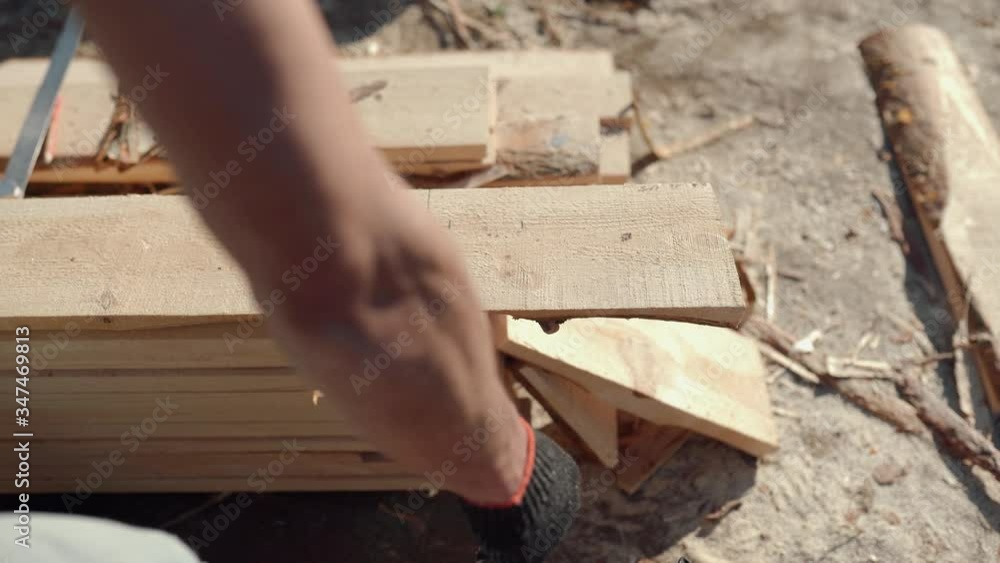 A man is sawing a board. Work with a tree. Saw boards. Build a house. Hand electric saw. Work carpenter. Do it yourself. A man is sawing a board. Work with a tree. Saw boards. Build a house. Hand electric saw. Work carpenter. Do it yourself.