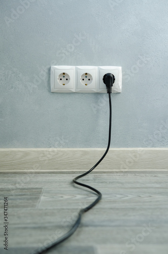 Close-up view of electric outlets with power cables photo