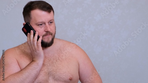 Wallpaper Mural fat naked bearded man talking on the phone, getting bad news, shocked insane evil gesture. Torontodigital.ca