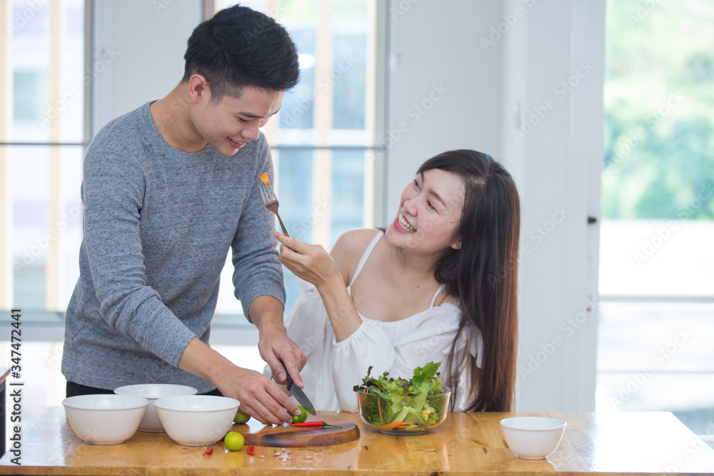 Asian couples making salads and eating cleanfood , healthy meals. Stay at home happily