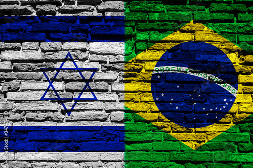 Flag of Israel and Brazil on brick wall © REDMASON