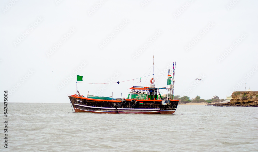 ferry boats sail on the sea from okha to dwarkadhish temple Gujarat India
