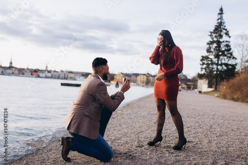 Couple in love together romantic date proposal of wedding outdoors on promenade