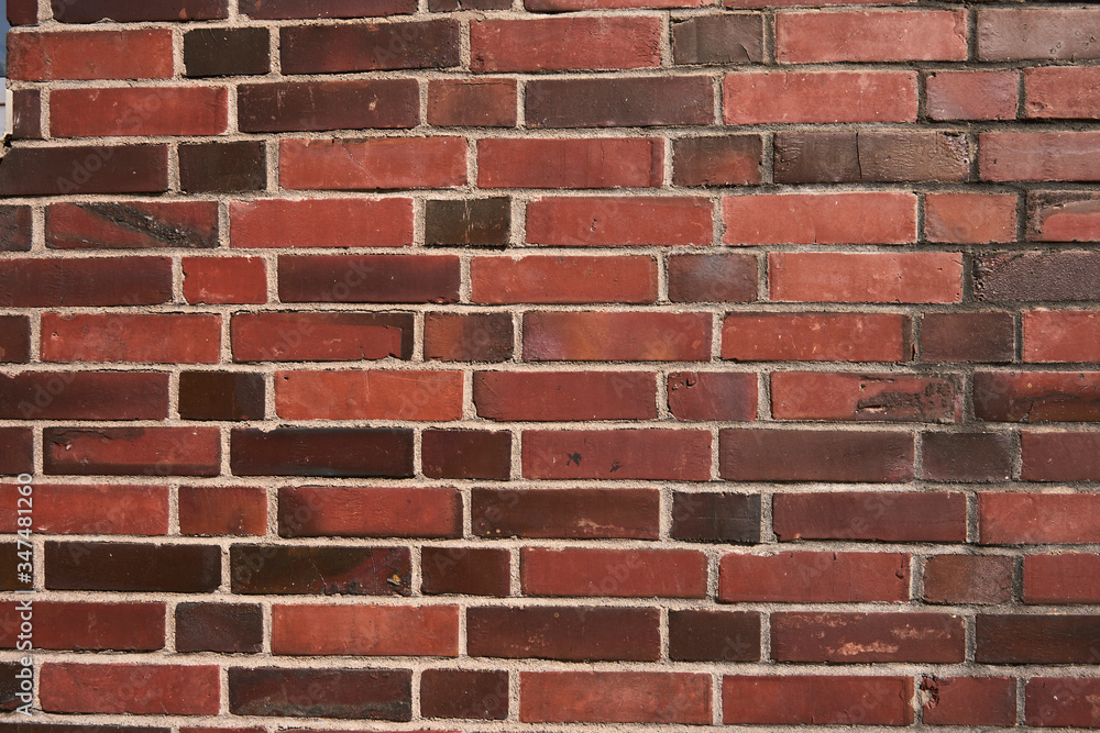 Texture of a mixed red brick wall