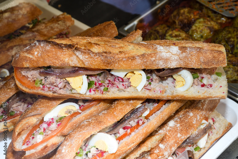 Tuna nicoise sandwich, also known as pan bagnat. The pan bagnat is a sandwich Tuna nicoise sandwich, also known as pan bagnat. The pan bagnat is a sandwich
