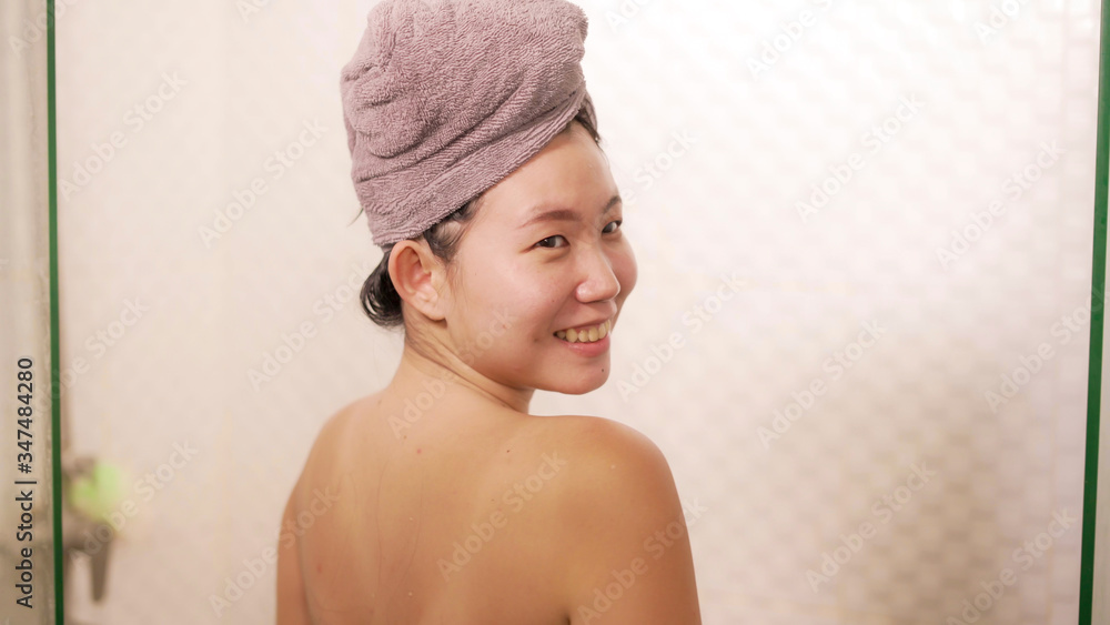 young beautiful and happy Asian Korean woman with head wrapped in towel smiling fresh and cheerful after taking shower enjoying morning routine and hygiene young beautiful and happy Asian Korean woman with head wrapped in towel smiling fresh and cheerful after taking shower enjoying morning routine and hygiene