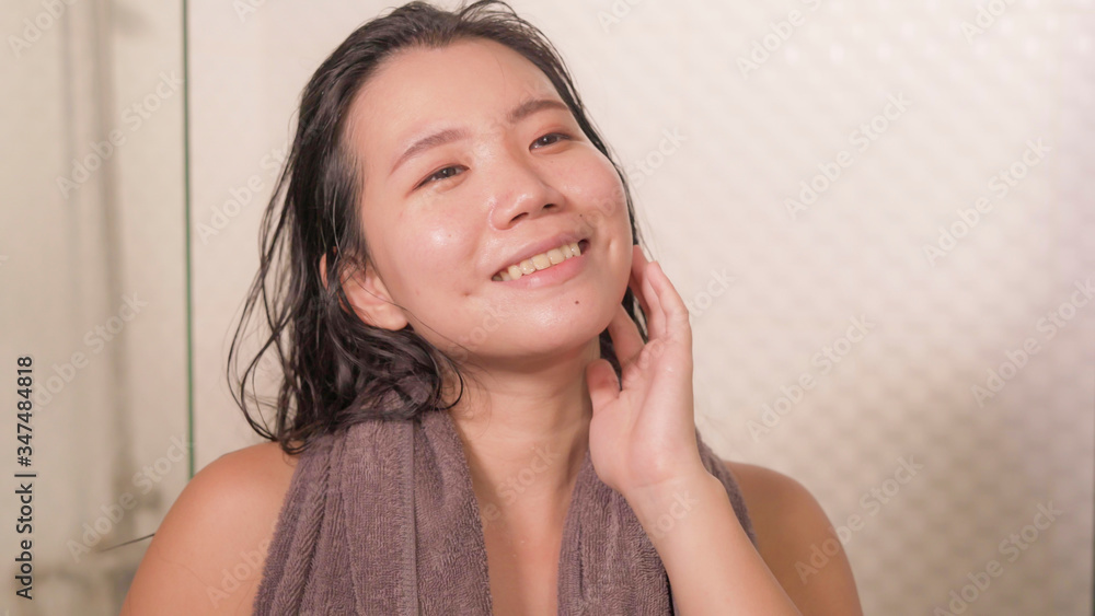 home lifestyle portrait of young beautiful and happy Asian Chinese woman with bath towel smiling fresh and cheerful after taking shower enjoying morning routine home lifestyle portrait of young beautiful and happy Asian Chinese woman with bath towel smiling fresh and cheerful after taking shower enjoying morning routine