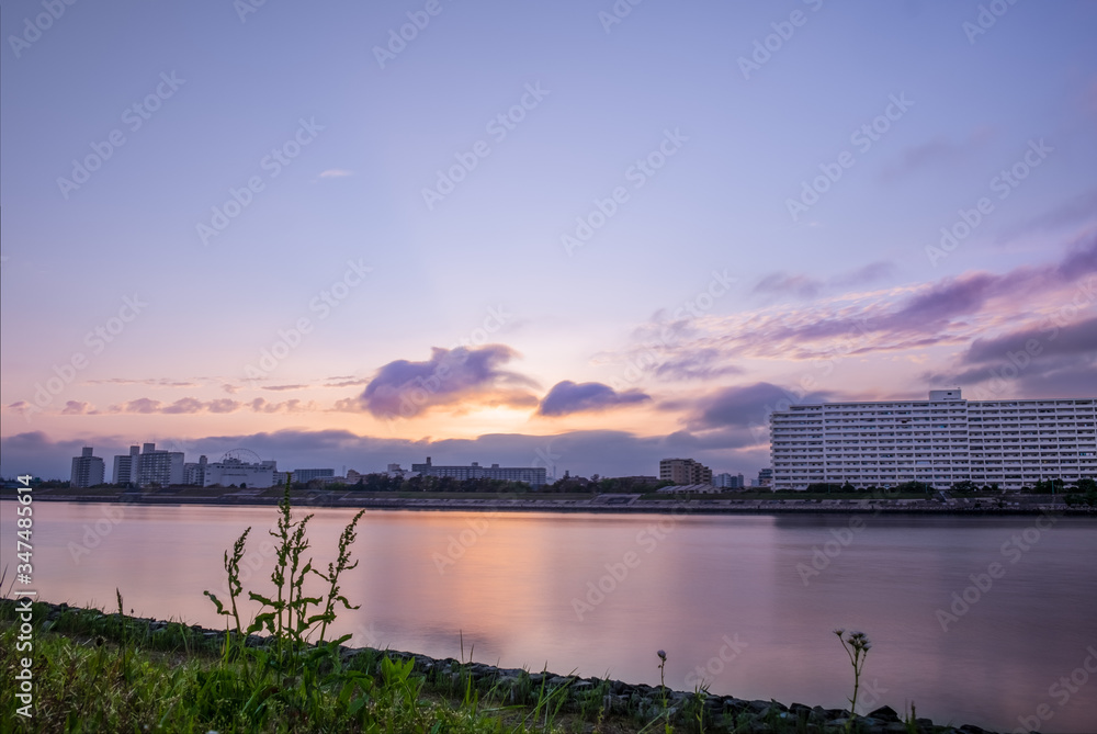 Fototapeta premium Panoramic sunset view of Kyuedogawa River in Maihama, Urayasu.