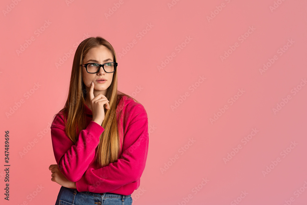 Girl with glasses looking at empty space Girl with glasses looking at empty space