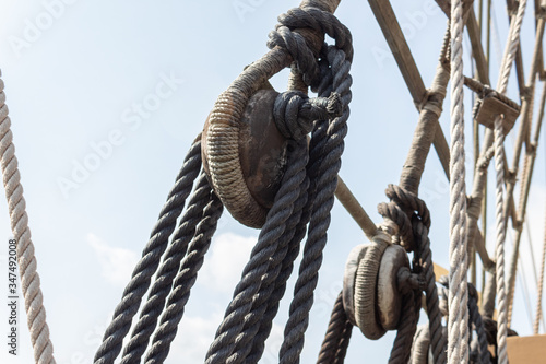 Fotografie Closeup of block and tackle, wrapped rope and rigging detail on an old sailing s