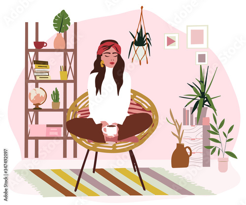 Stylish Scandic living room interior - sofa, armchair, coffee table, plants in pots, lamp, home decorations. Cozy Autumn seasone. Modern comfy apartment furnished in Hygge style, bohemian style