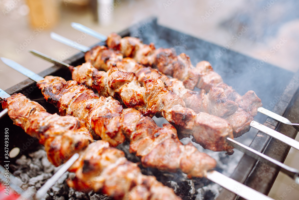 Bbq kebab grilling on open grill, outdoor kitchen. food festival in city.