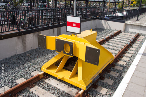 Closeup of yellow buffer stop of steel on railroad track