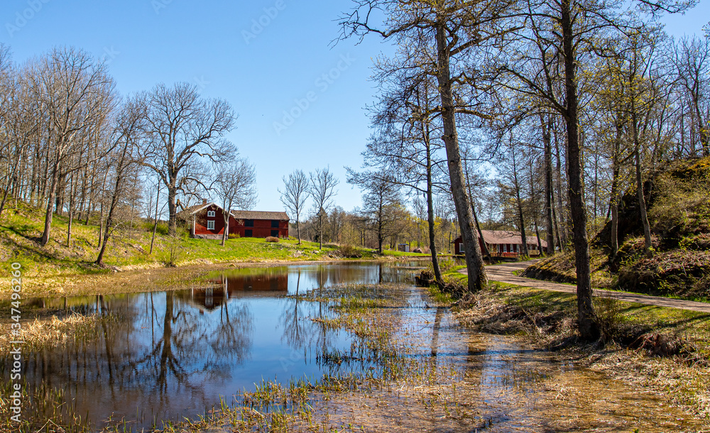 Spring landscape with a river and old house Spring landscape with a river and old house