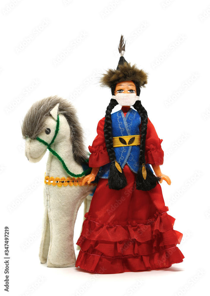 A doll in a Kazakh costume and a mask that protects against coronavirus