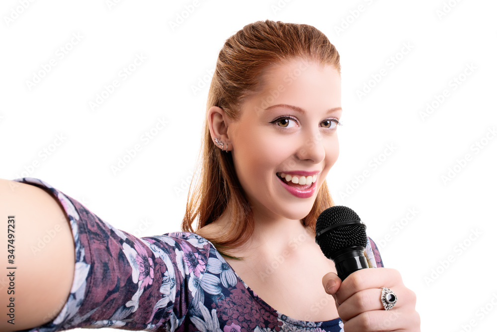 Happy young girl holding a microphone and taking a selfie Happy young girl holding a microphone and taking a selfie