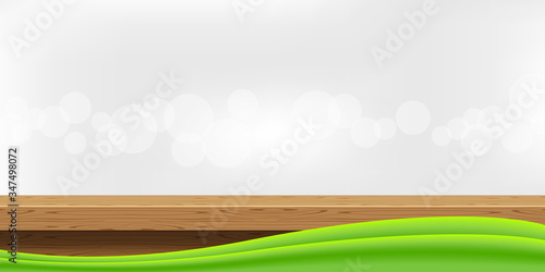 wood table front view and green graphic on bokeh soft grey, blank table top wooden for decoration room, wood plank for background, wooden board on grey wall, tabletop montage for copy space display ad