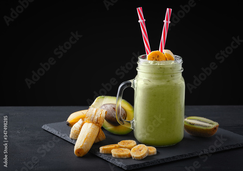 Fresh blended Banana, kiwi and avocado smoothie with yogurt or milk in mason jar, healthy eating. Copy space.