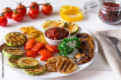 grilled vegetables served on a plate with tomato sauce