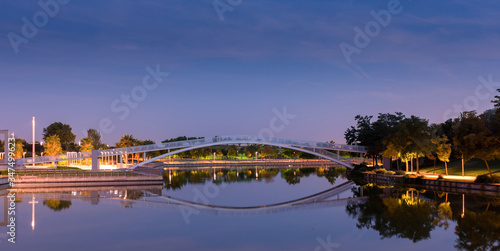 Bridge over an artificial lake reflected at night
