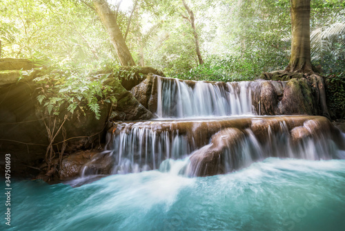 Fototapeta Naklejka Na Ścianę i Meble -  Waterfall and cascades in the jungle forest in Thailand. beautiful forest landscape, trees water and sun