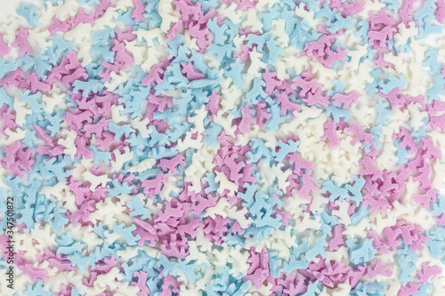 background of colorful unicorn sugar sprinkles in white, pink and blue
