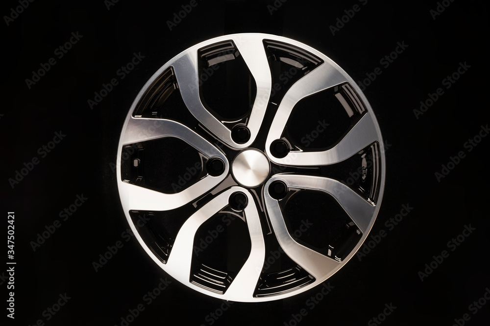 Obraz premium New car alloy wheel, close-up on a black background
