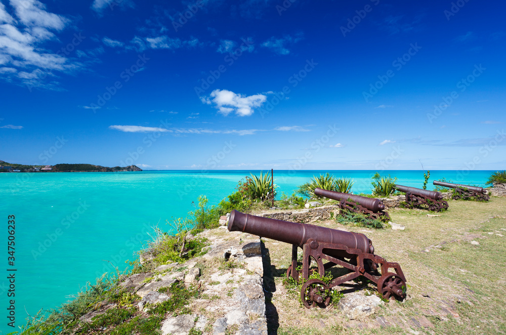 Row Of Cannons Overlooking Turquoise Caribbean Sea, Antigua Row Of Cannons Overlooking Turquoise Caribbean Sea, Antigua