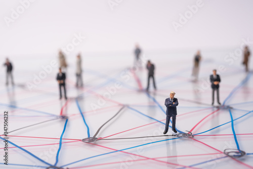 miniature people on connection line and dot , red black and blue line connect by black dot point , abstract people on complex network connection and communication, people social connection concept