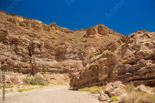 wilderness picturesque sand stone desert canyon landscape scenic view bare rocks and narrow pass drying warming nature environment