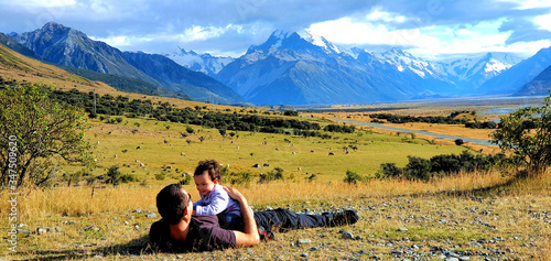 Father and child playing around happily, hugging and smiling while looking at each other