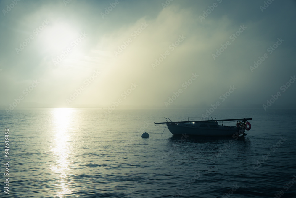 Single boat on water at sunset Single boat on water at sunset