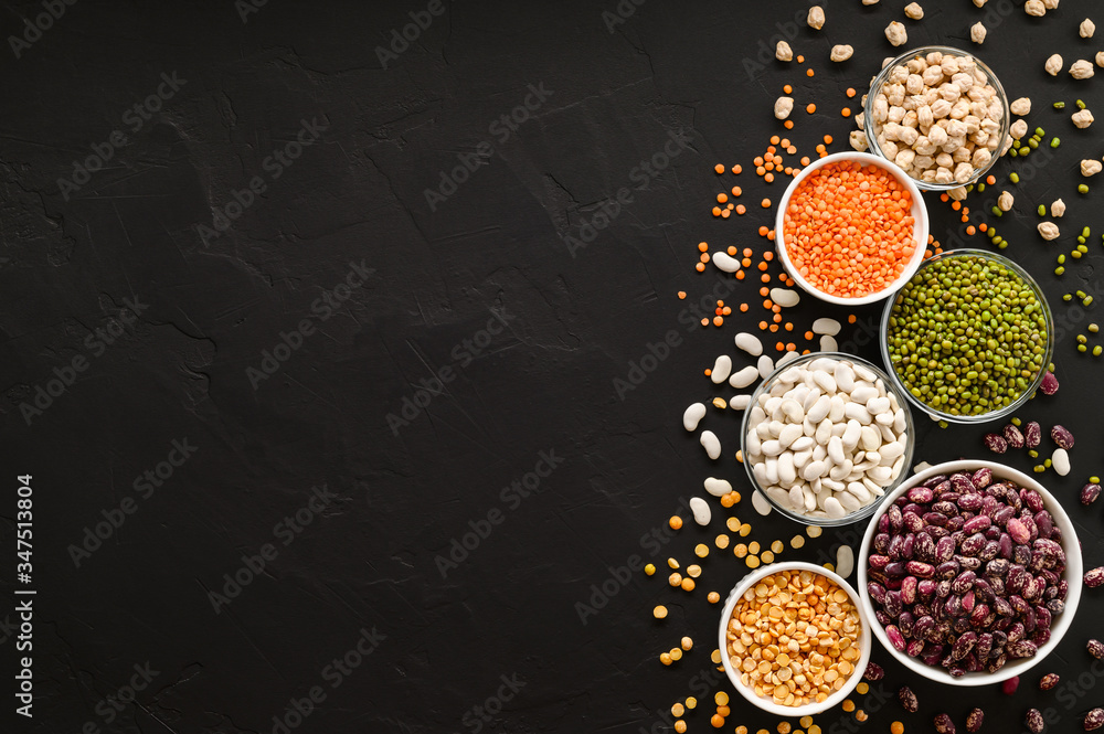 Various sources of vegetable protein: beans, lentils, peas, chickpeas, mung bean in bowls. A healthy balanced diet for vegans and vegetarians. Dark background. Flat lay, copy space. Various sources of vegetable protein: beans, lentils, peas, chickpeas, mung bean in bowls. A healthy balanced diet for vegans and vegetarians. Dark background. Flat lay, copy space.