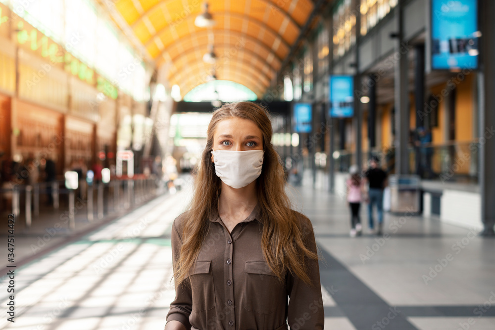 Woman wearing white protective face mask is using public transportation during the epidemic outbreak Woman wearing white protective face mask is using public transportation during the epidemic outbreak