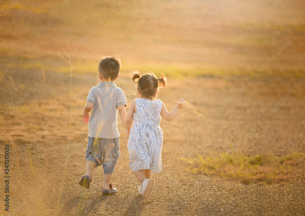 happy child boy and girl overall playing on sunny field, summer outdoor lifestyle, cozy mood happy child boy and girl overall playing on sunny field, summer outdoor lifestyle, cozy mood