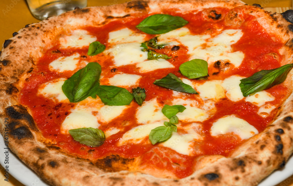 Pizza Margherita is a typical Neapolitan pizza, made with San Marzano tomatoes, mozzarella cheese Pizza Margherita is a typical Neapolitan pizza, made with San Marzano tomatoes, mozzarella cheese