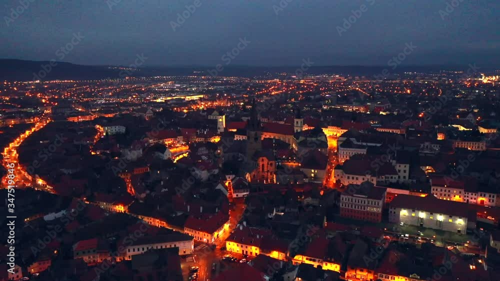 Night aerial view of towers of old city Sibiu in Romania. Towers of medieval city. City top view. Aerial view. Flight with the drone over the old city Night aerial view of towers of old city Sibiu in Romania. Towers of medieval city. City top view. Aerial view. Flight with the drone over the old city