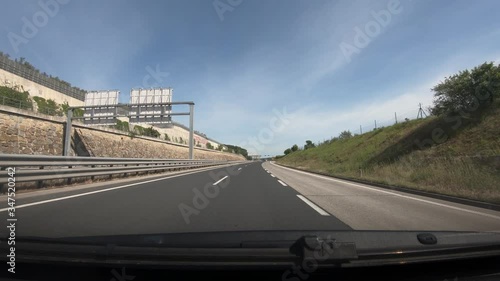 Dashboard point of view POV, driving on Slovenia highway. Dash cam view of asphalt road and karst landscape. Wide shot, forward dolly moving