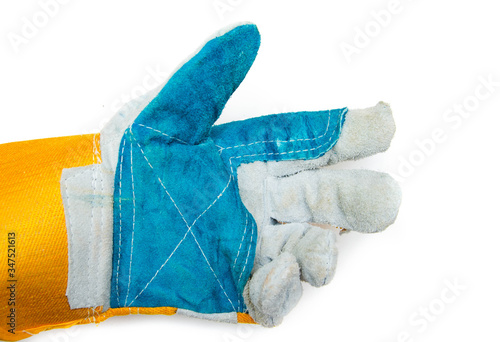 Gloves for workers, construction workers, gaiters. Men's mittens from a dense, strong fabric on a white background. Gloves in close-up on a male hand. Hand squeezes, indicates,  demonstrates photo