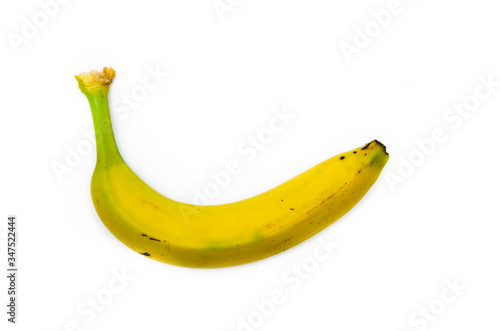 One banana top view on a white background. A beaten, scratched, rotten banana. Yellow banana with traces of transportation, bruising, damage
