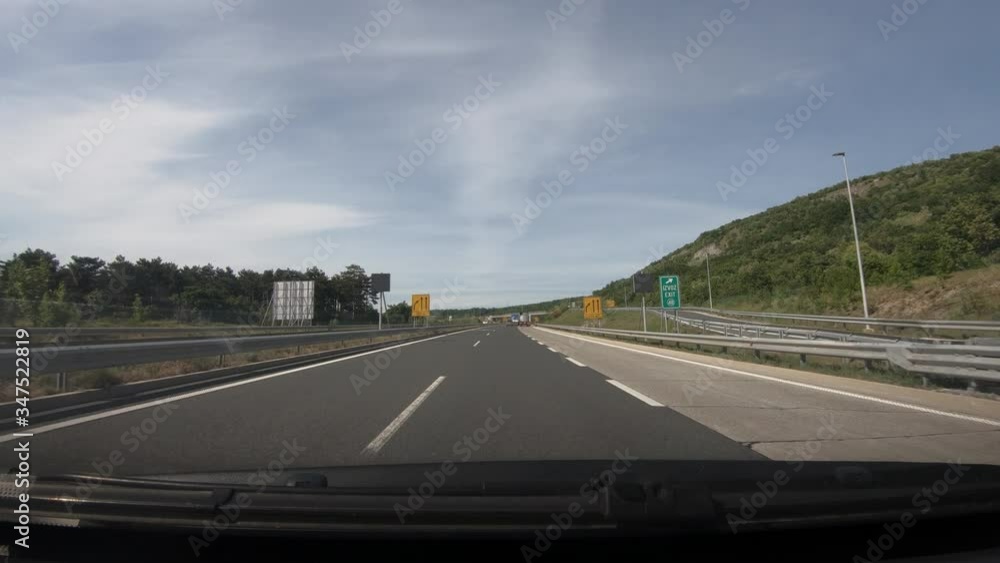 Dashboard point of view POV, driving on Slovenia highway. Dash cam view of asphalt road with beautiful landscape covered with pine trees. Wide shot, forward dolly moving Dashboard point of view POV, driving on Slovenia highway. Dash cam view of asphalt road with beautiful landscape covered with pine trees. Wide shot, forward dolly moving