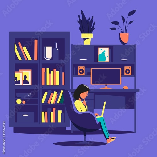 A girl sitting in a chair reading a book against the background of a bookcase and computer desk. Home leisure.