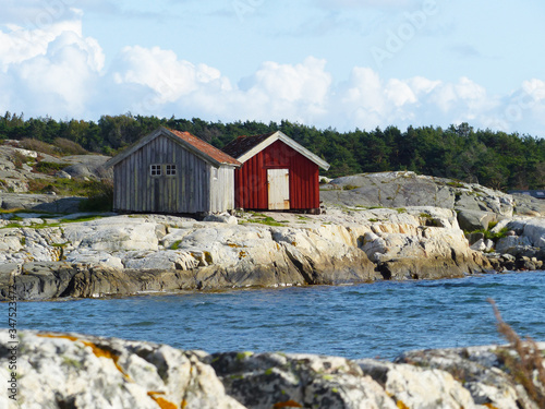 Burgundy wooden houses and landscapes in the Koster, Sydkoster and Nordkoster islands. Archipielago of Kosterhavets Nationalpark. Stromstad. Bohuslan. Sweden. photo