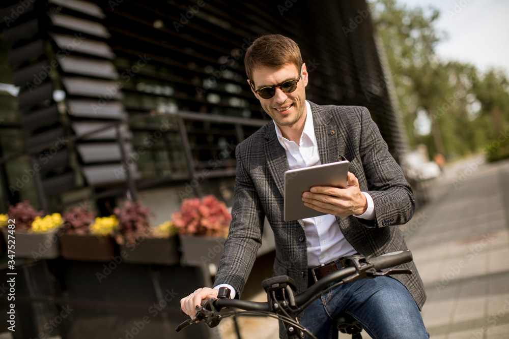 Young businessman on the ebike with digital tablet Young businessman on the ebike with digital tablet