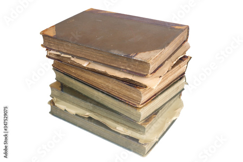 Stack of old vintage books reflecting on a white surface