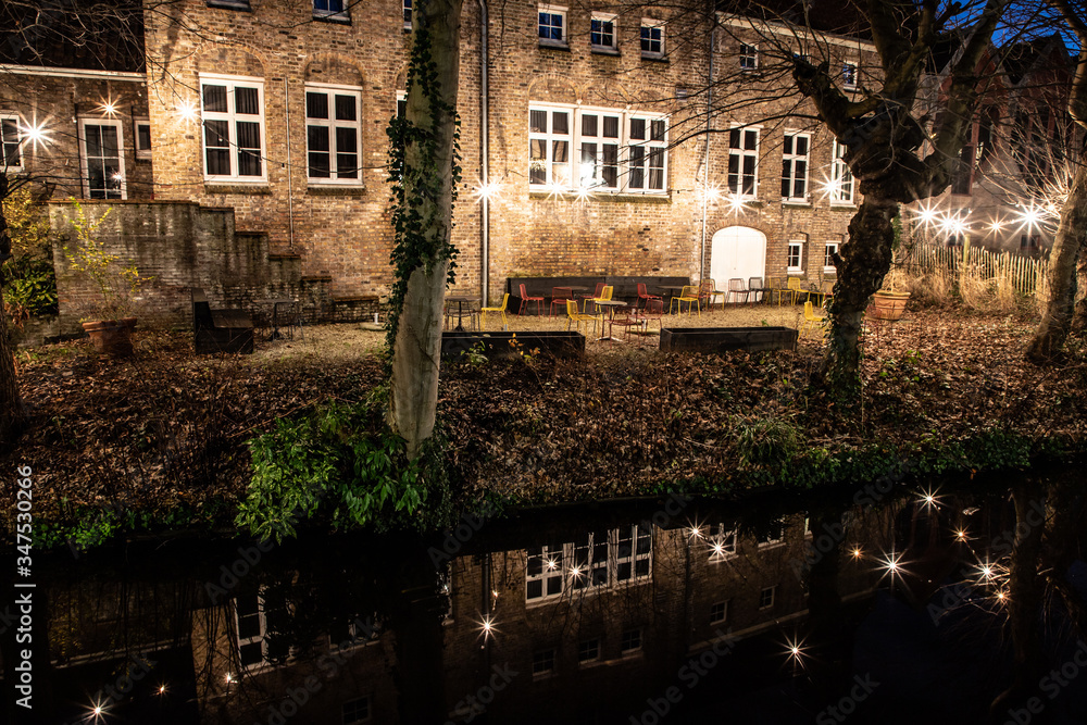 Light night with buildings with reflections  around channels in Bruges