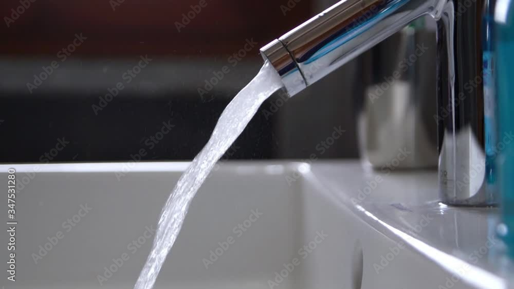 Slow motion of the flowing water of a sink in the bathroom. Slow motion of the flowing water of a sink in the bathroom.