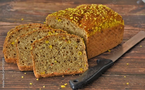 knife and bread baked with seeds and corn